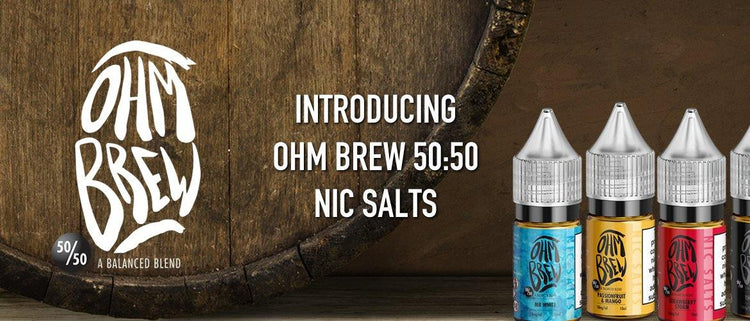 Ohm Brew 50:50 nic salts e-liquid bottles with bold labels next to wood barrel, vape product display